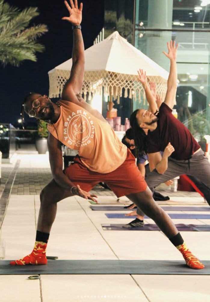 Philippe leading a rooftop yoga class at night